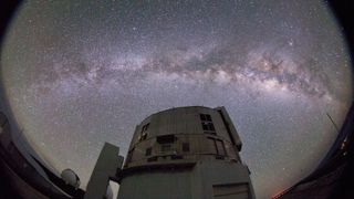 A photo of the Subaru Telescope against the night sky with the Milky Way clearly visible