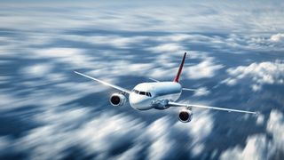 A commercial airliner soaring through the clouds.